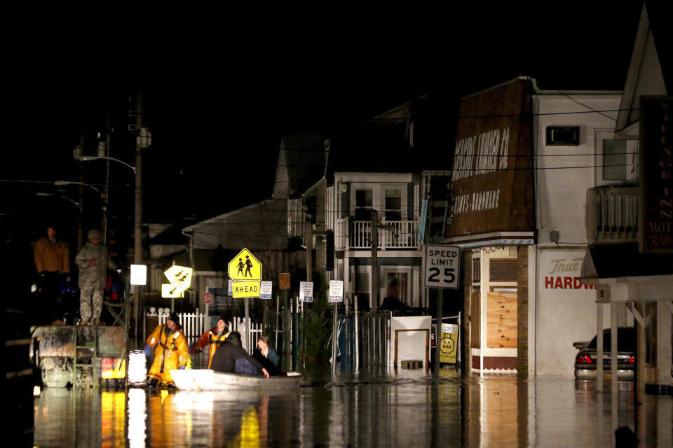 Rescue workers help stranded people out of their flooded homes in Seaside Heights, N.J., following the arrival of superstorm Sandy, Tuesday, Oct. 30, 2012. Sandy, the storm that made landfall Monday, caused multiple fatalities, halted mass transit and cut power to more than 6 million homes and businesses. (AP Photo/Julio Cortez)