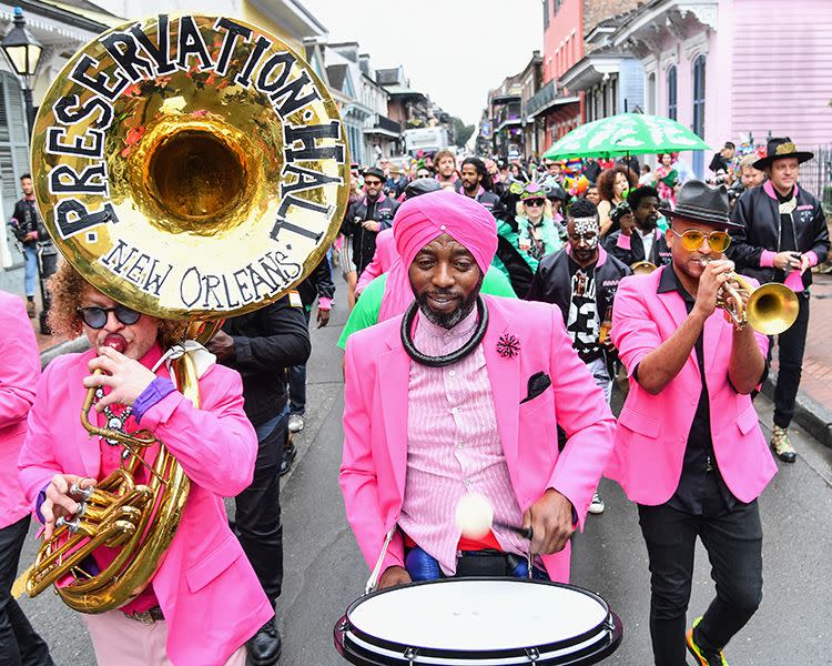 members of preservation hall jazz band, arcade fire and ram of haiti perform on the street in new orleans, a good housekeeping pick for best family vacation destination