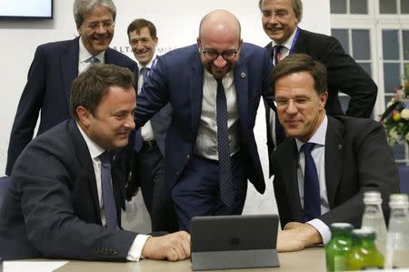 EU leaders including Belgian Prime Minister Charles Michel (C), Netherlands Prime Minister Mark Rutte (R), Luxembourg Prime Minister Xavier Bettel (L) and Italian Prime Minister Paolo Gentiloni (rear left) gather around a computer screen at the European Union leaders summit in Malta, February 3, 2017. REUTERS/Darrin Zammit-Lupi