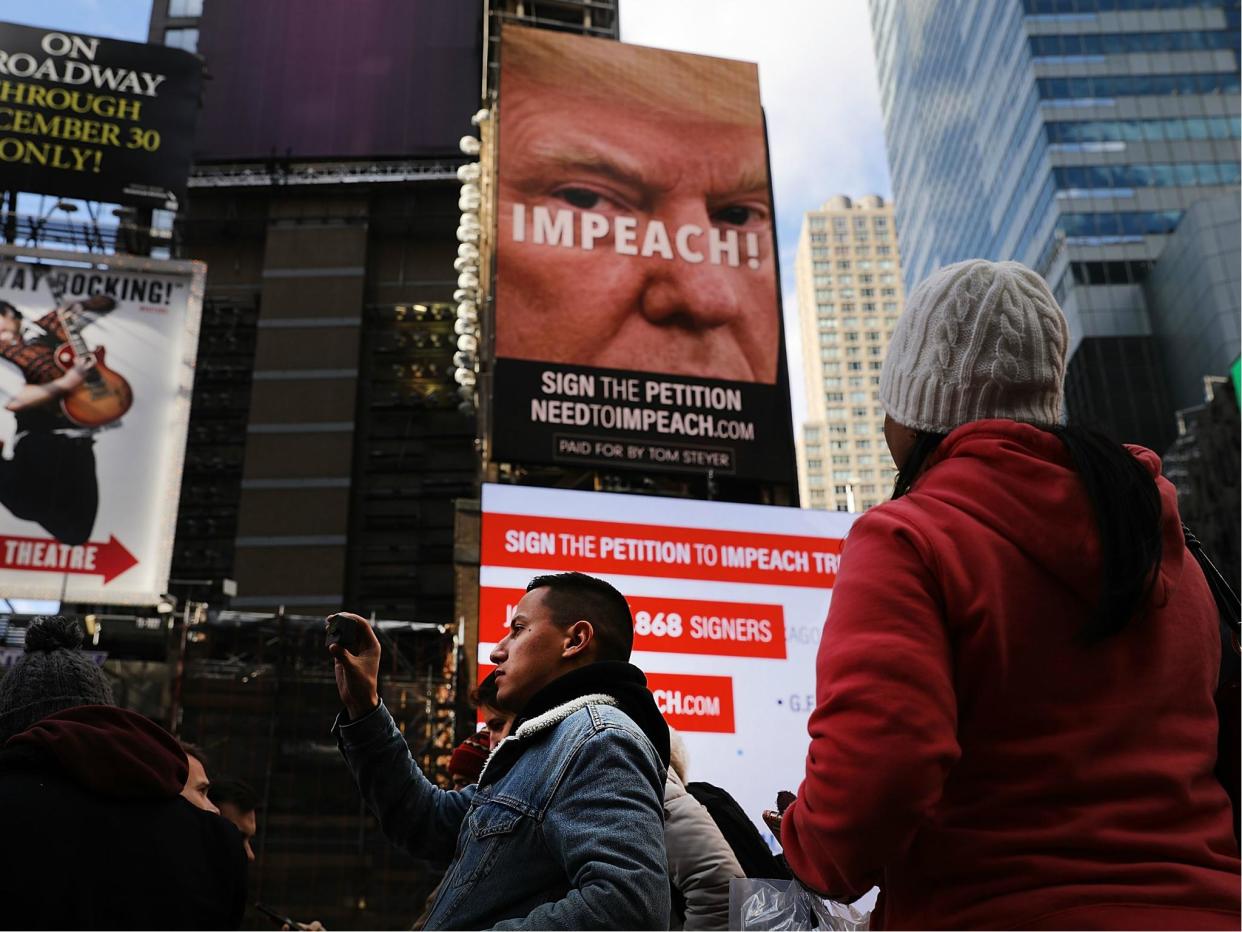 A billboard in Times Square, funded by Tom Steyer, calls for the impeachment of President Donald Trump on 20 November 2017 in New York City: Spencer Platt/Getty Images