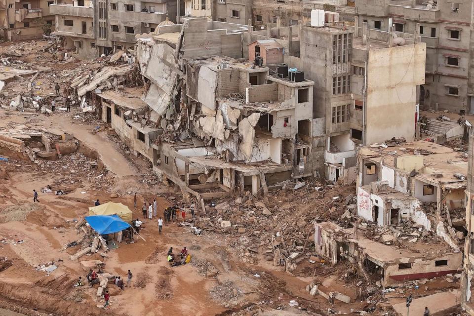 PHOTO: Rescuers and relatives of victims set up tents in front of collapsed buildings in Derna, Libya, Monday, Sept. 18, 2023. (Muhammad J. Elalwany/AP)