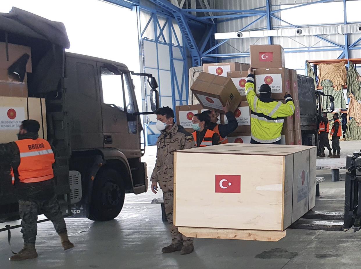 Spanish soldiers unload Personal Protection Equipment donated by Turkey to help the country combat the new coronavirus outbreak, in Madrid, Spain, on Wednesday, April 1, 2020.