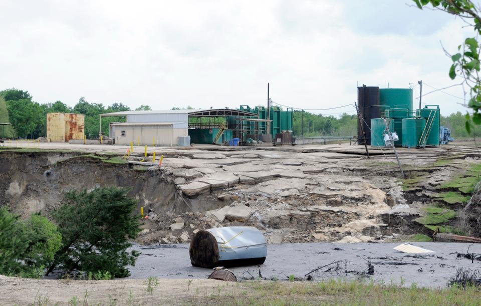 A water tank floats at the bottom of a sinkhole as it continues to grow Wednesday, May 7, 2008  in Daisetta, Texas.