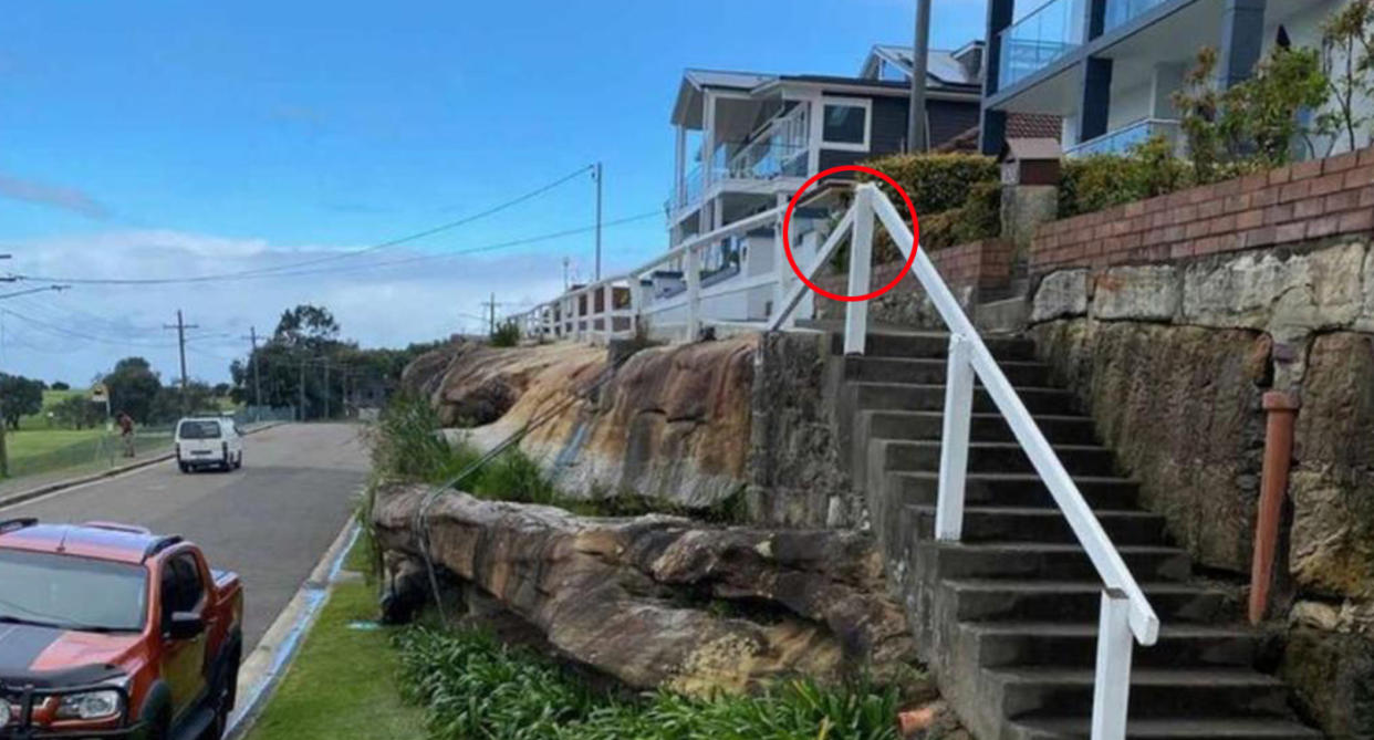 Broken white timber railing on walkway on Prince Edward Street in Malabar, Sydney. 