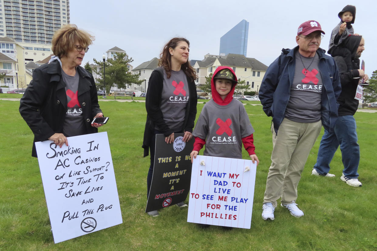 Family members of casino dealers attend a rally urging the city to eliminate smoking in casinos, April 12, 2022, in Atlantic City, N.J. (AP Photo/Wayne Parry)