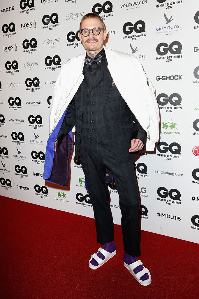 <p>The designer shows off his eccentric style in white sandals and purple socks at the <i>GQ</i> Men of the Year Awards 2016 in Germany. <i> (Photo: Franziska Krug/Getty Images for GQ) </i> </p>