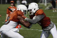 Texas wide receiver John Burt, left, and wide receiver Collin Johnson, right, go through drills during a morning practice at the NCAA college football team's facility in Austin, Texas, Wednesday, Aug. 7, 2019. (AP Photo/Eric Gay)