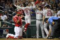 Boston Red Sox's Enrique Hernandez (5) celebrates his two-run home run with Bobby Dalbec, second from right, and Travis Shaw (23) during the ninth inning of a baseball game Saturday, Oct. 2, 2021, in Washington. Washington Nationals catcher Keibert Ruiz is at from left. The Red Sox won 5-3.(AP Photo/Nick Wass)