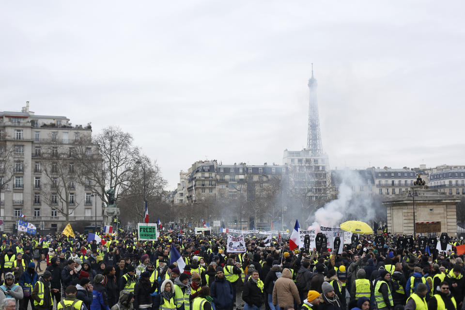 Yellow vest protesters march Saturday, Jan. 19, 2019 in Paris. Yellow vest protesters are planning rallies in several French cities despite a national debate launched this week by President Emmanuel Macron aimed at assuaging their anger. (AP Photo/Thibault Camus)