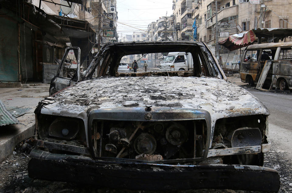 A burnt car is pictured in a rebel-held sector of eastern Aleppo