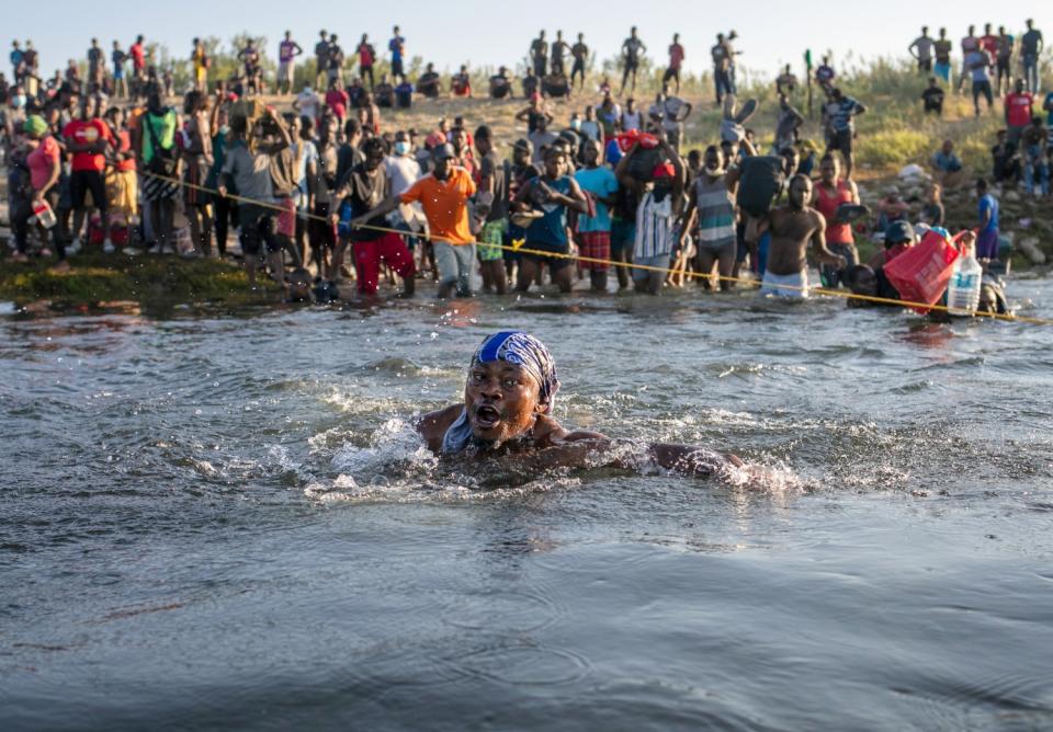 Haitian immigrants cross the Rio Grande back into Mexico from Del Rio, Texas, on Monday