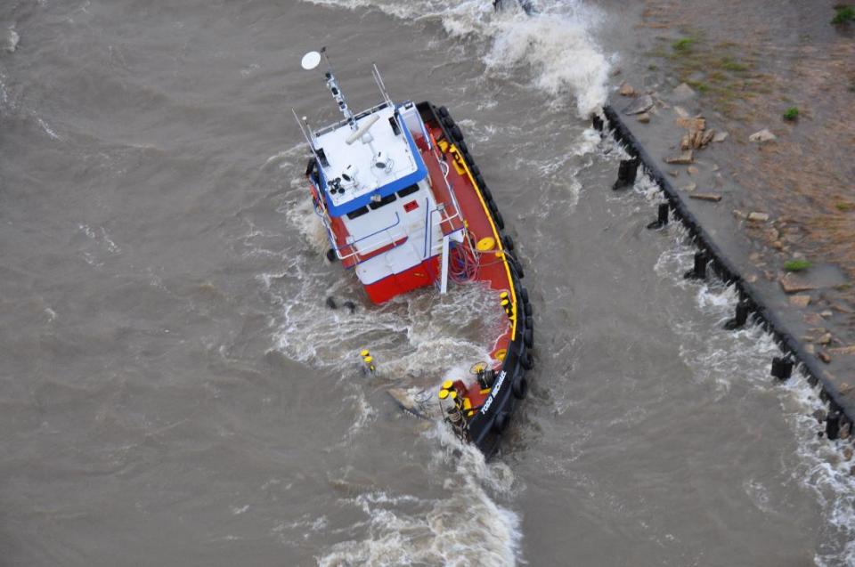 The uninspected towing vessel Todd Michael is grounded on Lake Pontchartrain, Tuesday April 15, 2014. The Coast Guard rescued three crewmembers from the vessel after receiving the report from the UTV Todd Michael. (AP Photo/U.S. Coast Guard Air Station New Orleans)