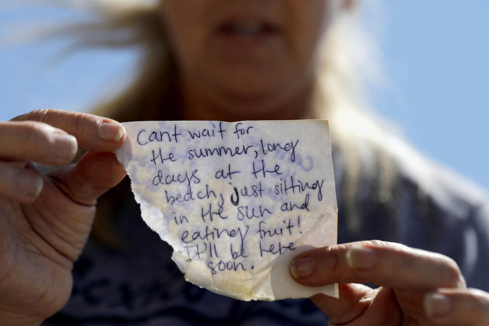 Candace Phillips holds a note she found in the rubble that her daughter left on a recent visit to their now-damaged home in Mexico Beach. "We spent 25 years of our marriage working to get here and we're going to stay," said Phillips of her and her husband's plans to rebuild.