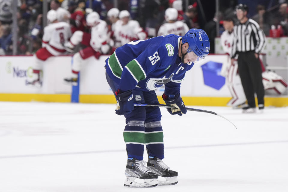 Vancouver Canucks' Bo Horvat pauses on the ice after the Carolina Hurricanes defeated Vancouver 3-2 during an NHL hockey game in Vancouver, British Columbia, on Monday, Oct. 24, 2022. (Darryl Dyck/The Canadian Press via AP)