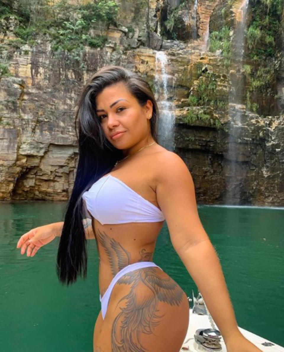 Julia Renata Garcia poses in a bikini in front of a waterfall. 