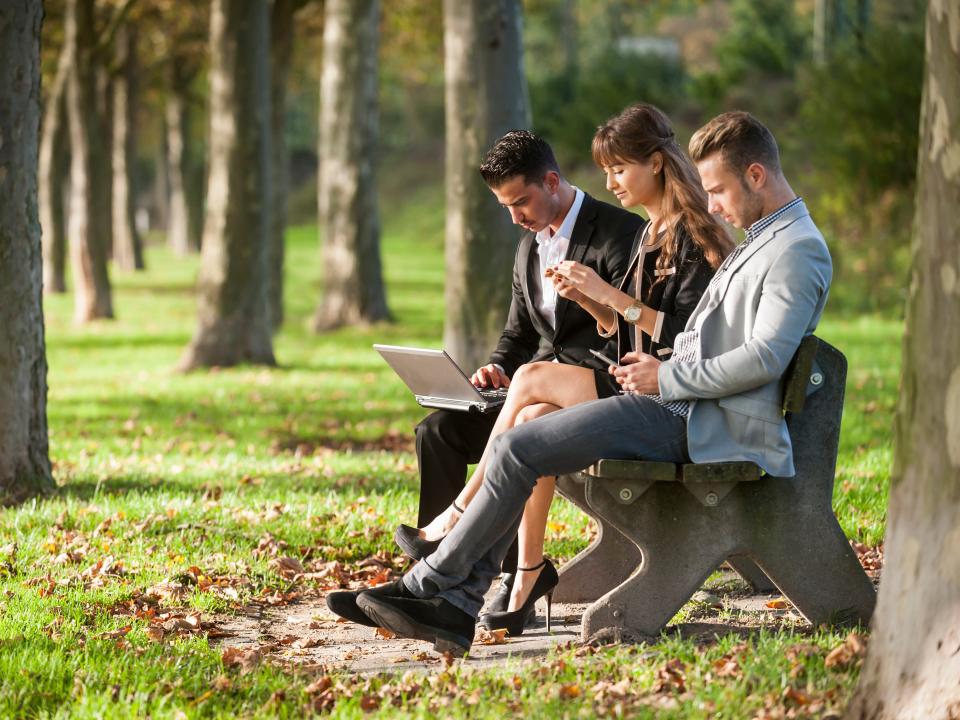 People sharing a park bench.