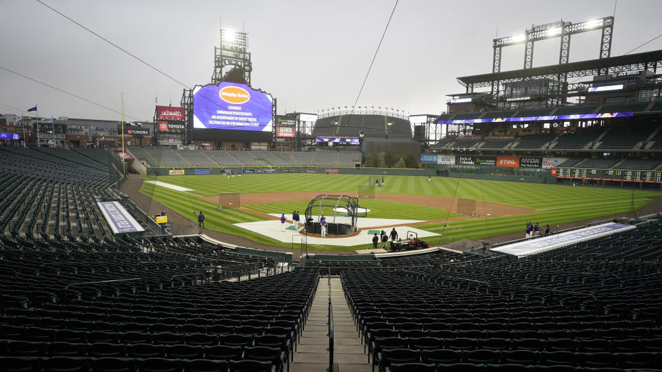Players take part in batting practice as a light rain descends on Coors Field Tuesday, April 6, 2021, before the Colorado Rockies host the Arizona Diamondbacks in a baseball game in Denver. Major League Baseball announced that Coors Field will be the venue for the 2021 All-Star Game after the Midsummer Classic was moved out of Atlanta because of sweeping changes to voting rights established in the state of Georgia. (AP Photo/David Zalubowski)