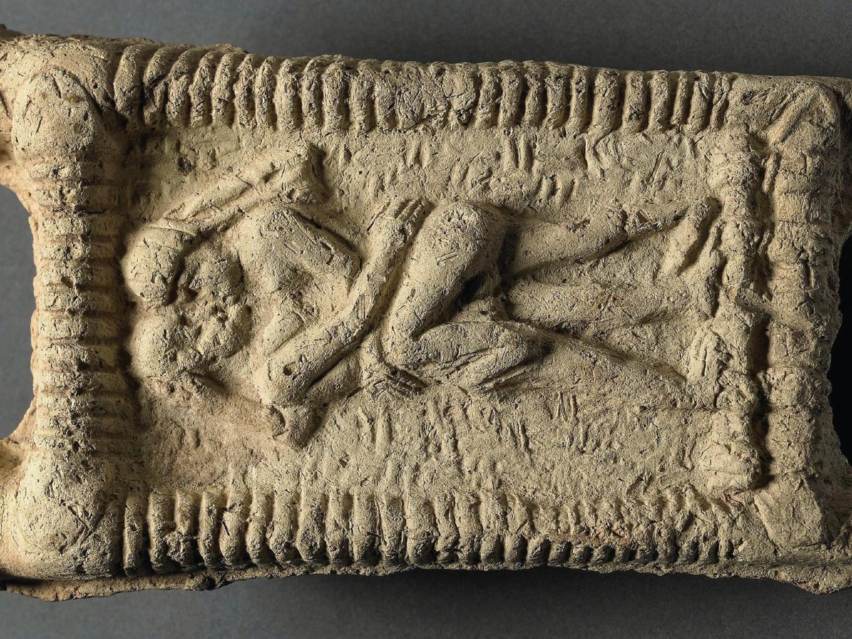 Babylonian clay model showing a nude couple on a couch engaged in sex and kissing. Date: 1800 BC.