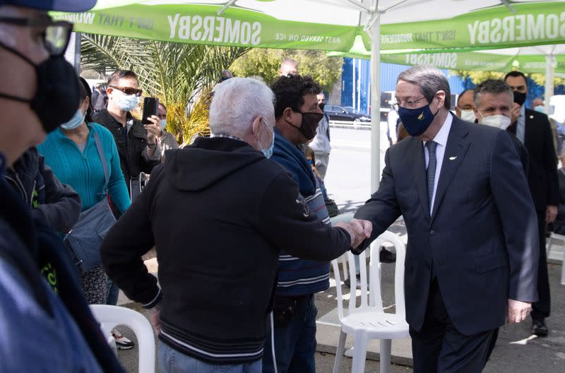 Cypriot President Nicos Anastasiades greets a citizens during a visit at a vaccination centre where his government ministers received a dose of AstraZeneca coronavirus disease (COVID-19) vaccine in Nicosia