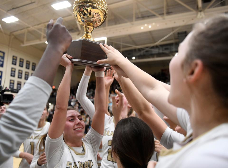 Amarillo High's Kirbi Simpson holds the Region I-5A quarterfinal basketball trophy after defeating Monterey, Monday, Feb. 19, 2024, at the Hutcherson Center in Plainview.