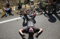 Scores of riders lie on the road after a fall during the 159,5 km (99 miles) third stage of the 102nd Tour de France cycling race from Anvers to Huy, Belgium, July 6, 2015. REUTERS/Benoit Tessier