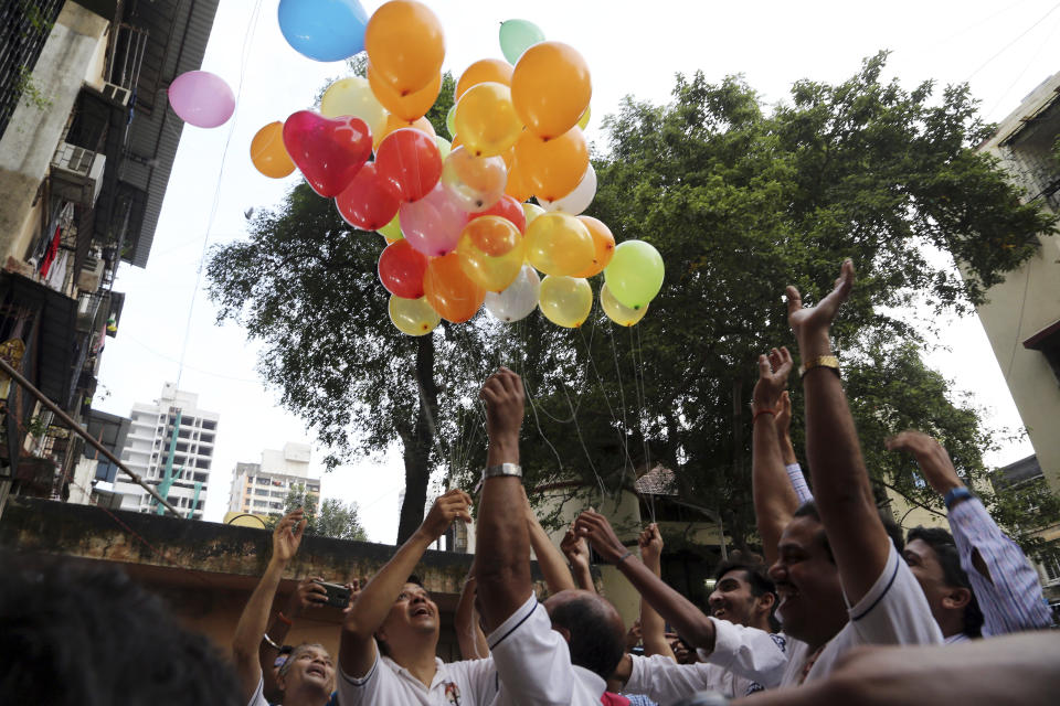 Indian friends of Kulbhushan Jadhav, celebrate verdict of International Court of Justice in Mumbai, India, Wednesday, July 17, 2019. The United Nations' highest court has ordered that Pakistan stay the execution of Jadhav, an alleged Indian spy and ordered that his case be reviewed after agreeing with India's contention that his rights had been violated. (AP Photo/Rajanish Kakade)