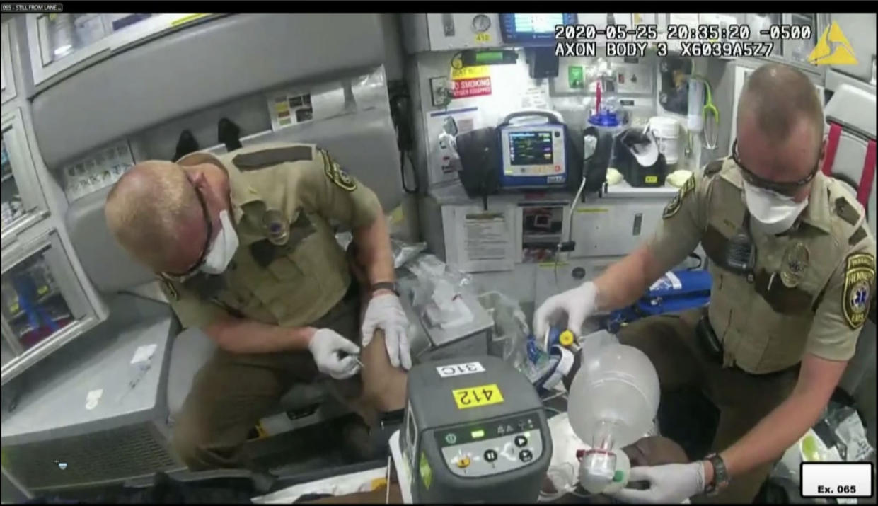 Derek Smith and Seth Zachary Bravinder, Hennepin County paramedics work to resucitate George Floyd on May 25, 2020 in this video evidence in the Derek Chauvin trial in Minneapolis, MN. on April 1, 2021. (Court TV via Reuters Video)