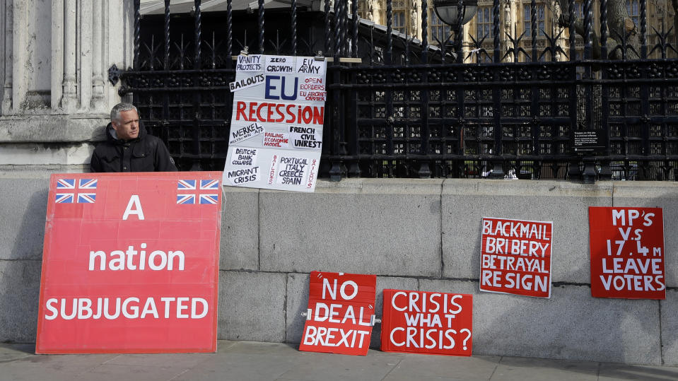 A pro Brexit campaigner leans on the wall outside Parliament in London, Monday, March 25, 2019. British Prime Minister Theresa May is under intense pressure Monday to win support for her Brexit deal to split from Europe.(AP Photo/Kirsty Wigglesworth)