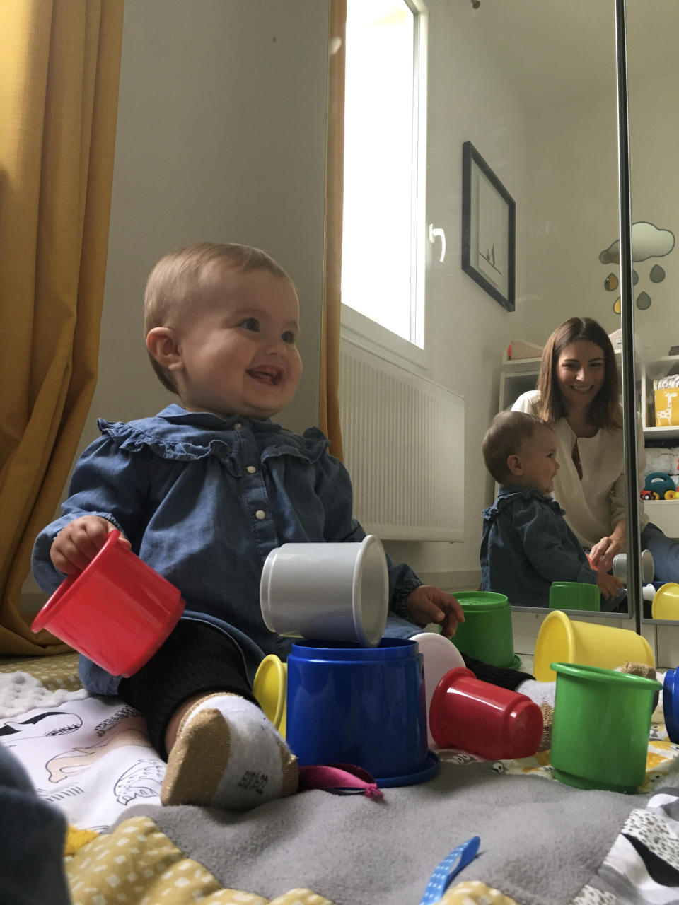 10-month old daughter Emilia, who was conceived through in-vitro fertilization, smiles to her mother Sandrine Rudnicki, a 38 years old single woman, Monday Oct.14, 2019 in Saint-Pryve-Saint-Mesmin, near Orleans, France. France's lower house of parliament is set to adopt a bill that would give single women and lesbian couples access to in-vitro fertilization and related procedures. (AP Photo/Nicolas Garriga)