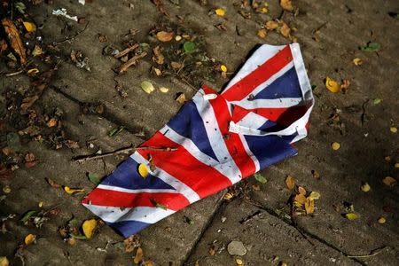A British flag which was washed away by heavy rains the day before lies on the street in London, Britain, June 24, 2016 after Britain voted to leave the European Union in the EU BREXIT referendum. REUTERS/Reinhard Krause