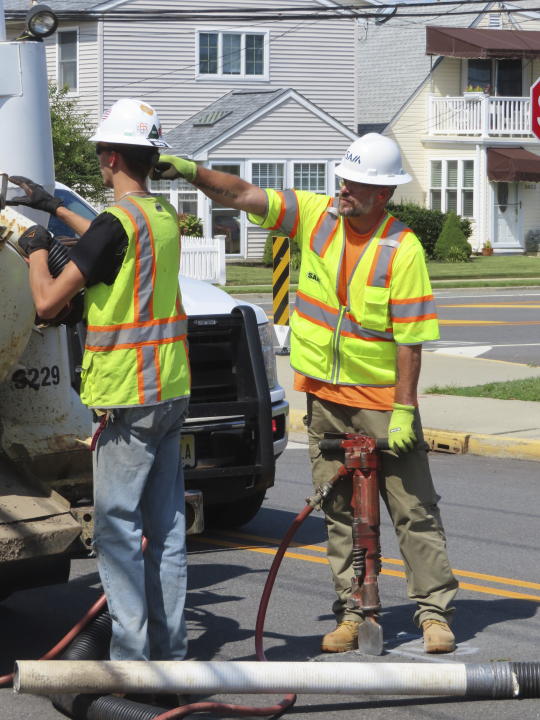 A worker uses a jackhammer to open a section of the street in Ocean City, N.J. on Sept. 12, 2023, at the start of land-based probing along the right-of-way where a power cable for New Jersey's first offshore wind farm is proposed to run. Several protestors were arrested trying to block the work for the project being done by Danish wind energy company Orsted. (AP Photo/Wayne Parry)