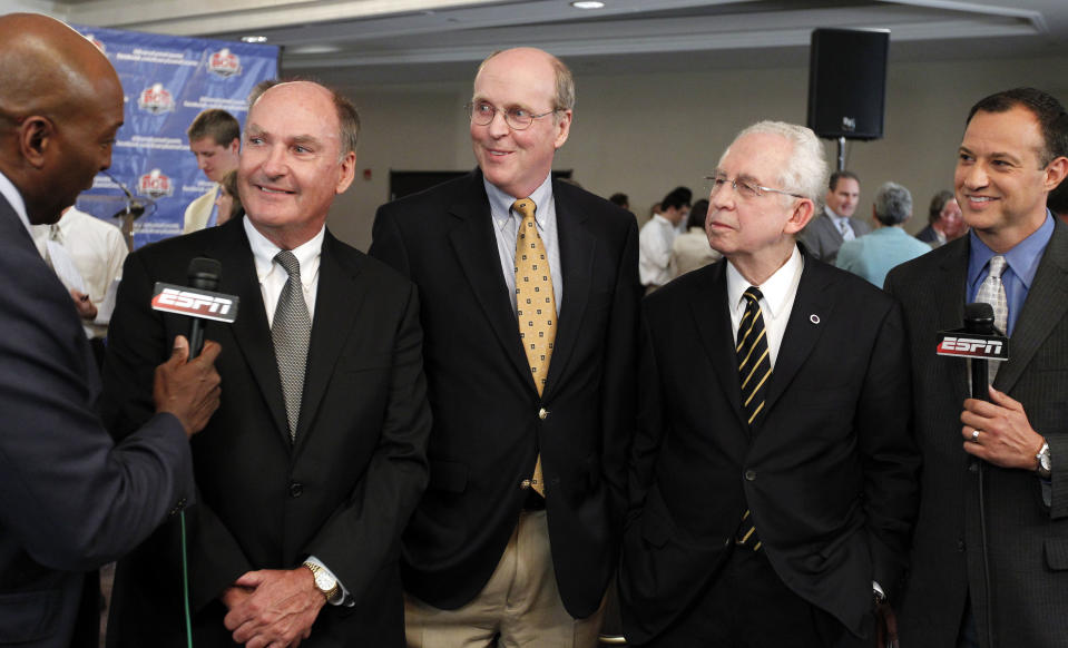 Big Ten Commissioner Jim Delany, second from left, BCS executive director Bill Hancock, center, and SEC Commissioner Mike Slive, second from right, smile during an interview after a BCS presidential oversight committee meeting and media availability, Tuesday, June 26, 2012, in Washington. A committee of university presidents on Tuesday approved the BCS commissioners' plan for a four-team playoff to start in the 2014 season. (AP Photo/Alex Brandon)