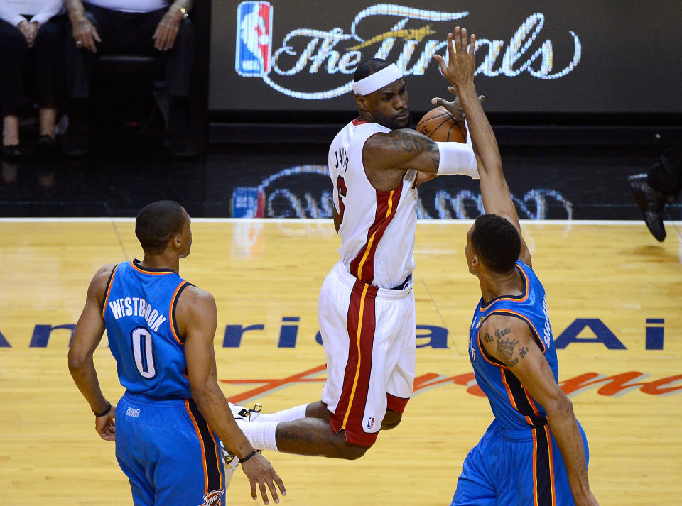 MIAMI, FL - JUNE 17: LeBron James #6 of the Miami Heat attempts to control the ball in the first quarter against Russell Westbrook #0 and Thabo Sefolosha #2 of the Oklahoma City Thunder in Game Three of the 2012 NBA Finals on June 17, 2012 at American Airlines Arena in Miami, Florida. NOTE TO USER: User expressly acknowledges and agrees that, by downloading and or using this photograph, User is consenting to the terms and conditions of the Getty Images License Agreement. (Photo by Ronald Martinez/Getty Images)