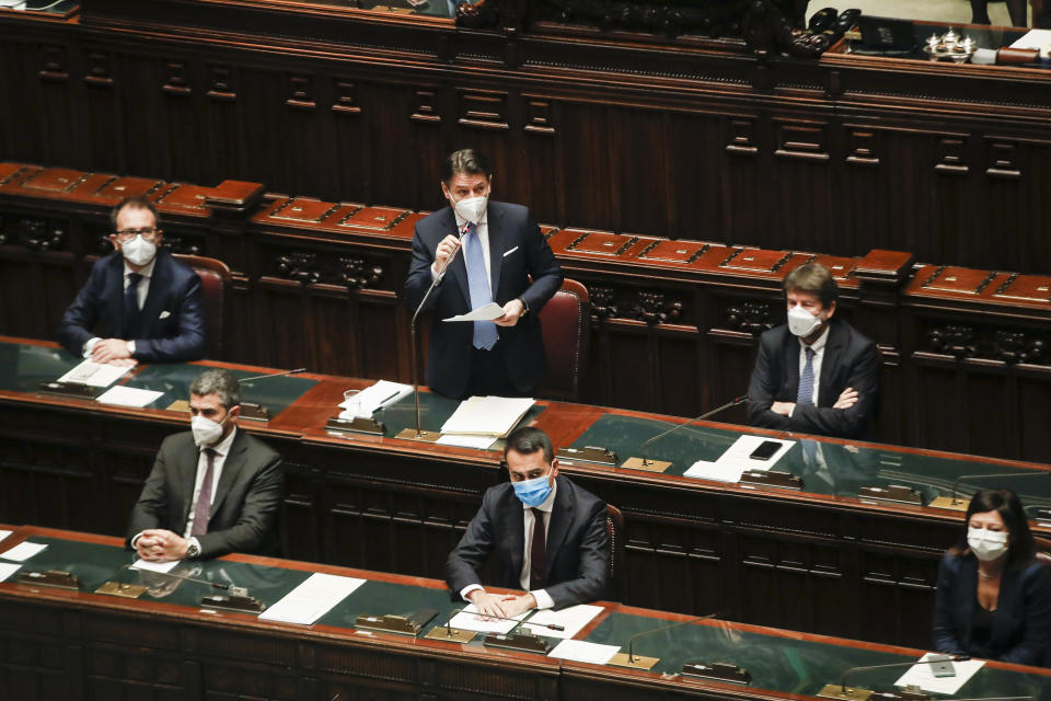 Premier Giuseppe Conte, top center, delivers his speech at the lower chamber of Parliament, in Rome, Monday, Jan. 18, 2021. Conte fights for his political life with an address aimed at shoring up support for his government, which has come under fire from former Premier Matteo Renzi's tiny but key Italia Viva (Italy Alive) party over plans to relaunch the pandemic-ravaged economy. (AP Photo/Alessandra Tarantino, pool)