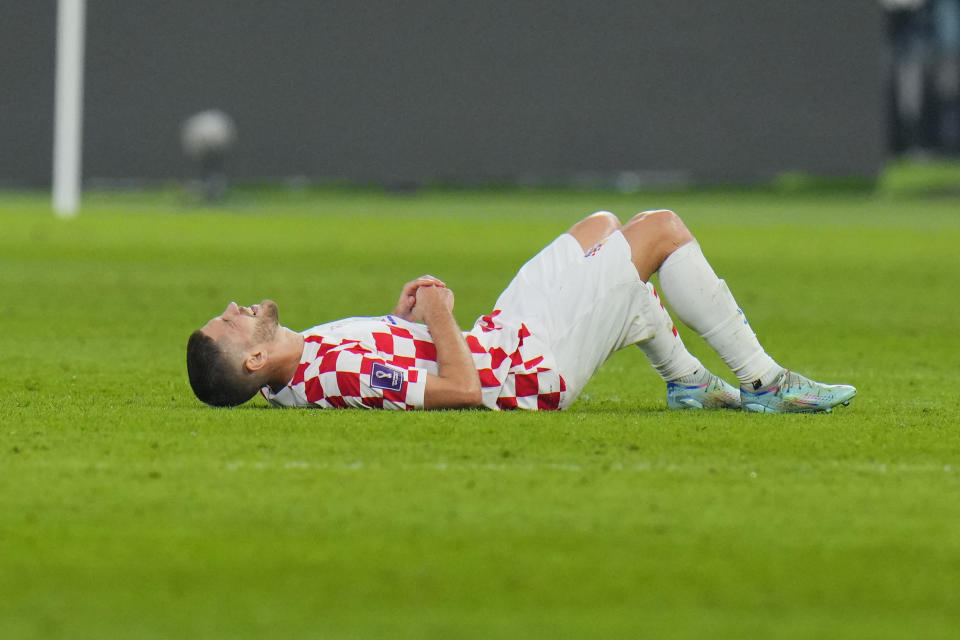 Croatia's Andrej Kramaric grimaces in pain during the World Cup third-place playoff soccer match between Croatia and Morocco at Khalifa International Stadium in Doha, Qatar, Saturday, Dec. 17, 2022. (AP Photo/Hassan Ammar)
