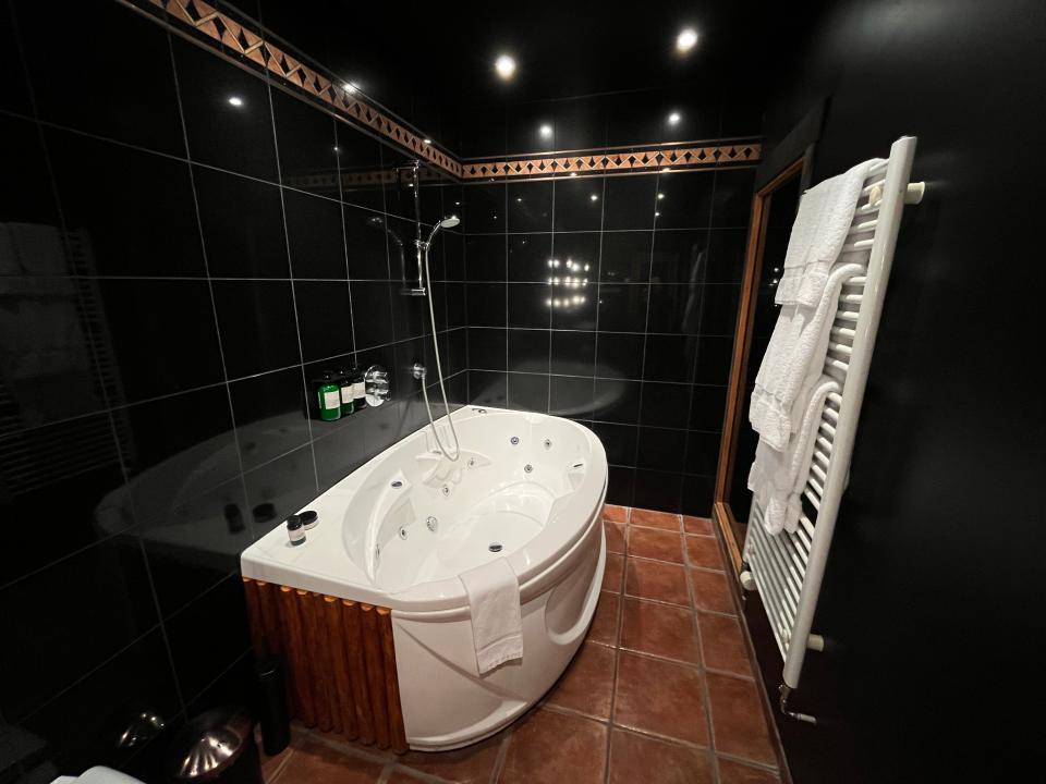 The bathroom with a whirlpool bathtub at Hotel Ranga.