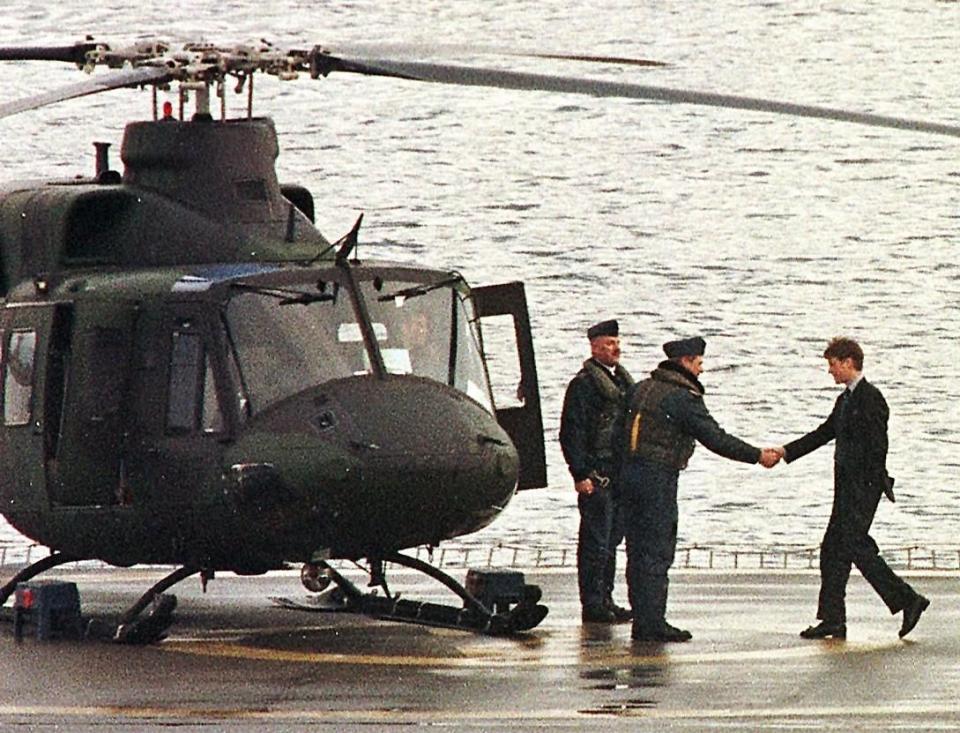 prince william r shakes hands with a pilot as he