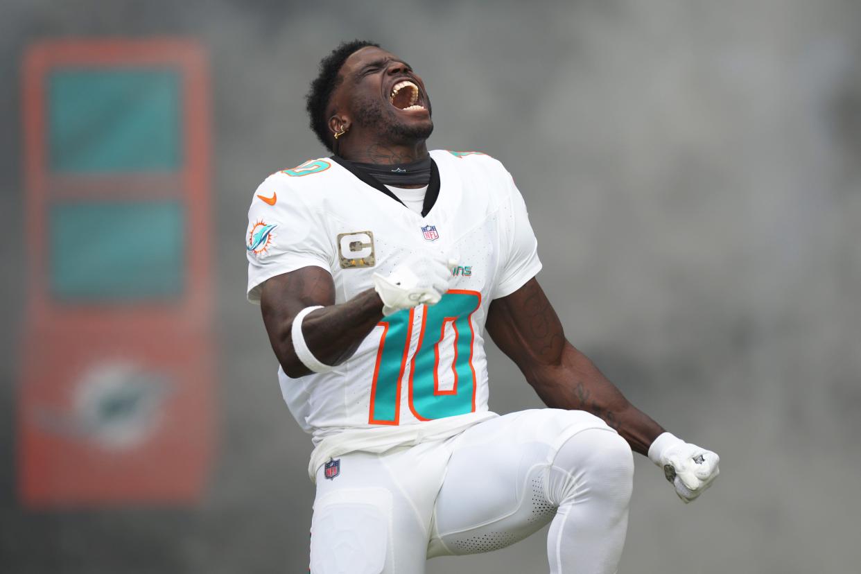 Miami Dolphins wide receiver Tyreek Hill (10) runs onto the field during pregame ceremonies of an NFL game against the Las Vegas Raiders at Hard Rock Stadium in Miami Gardens, Nov. 19, 2023.