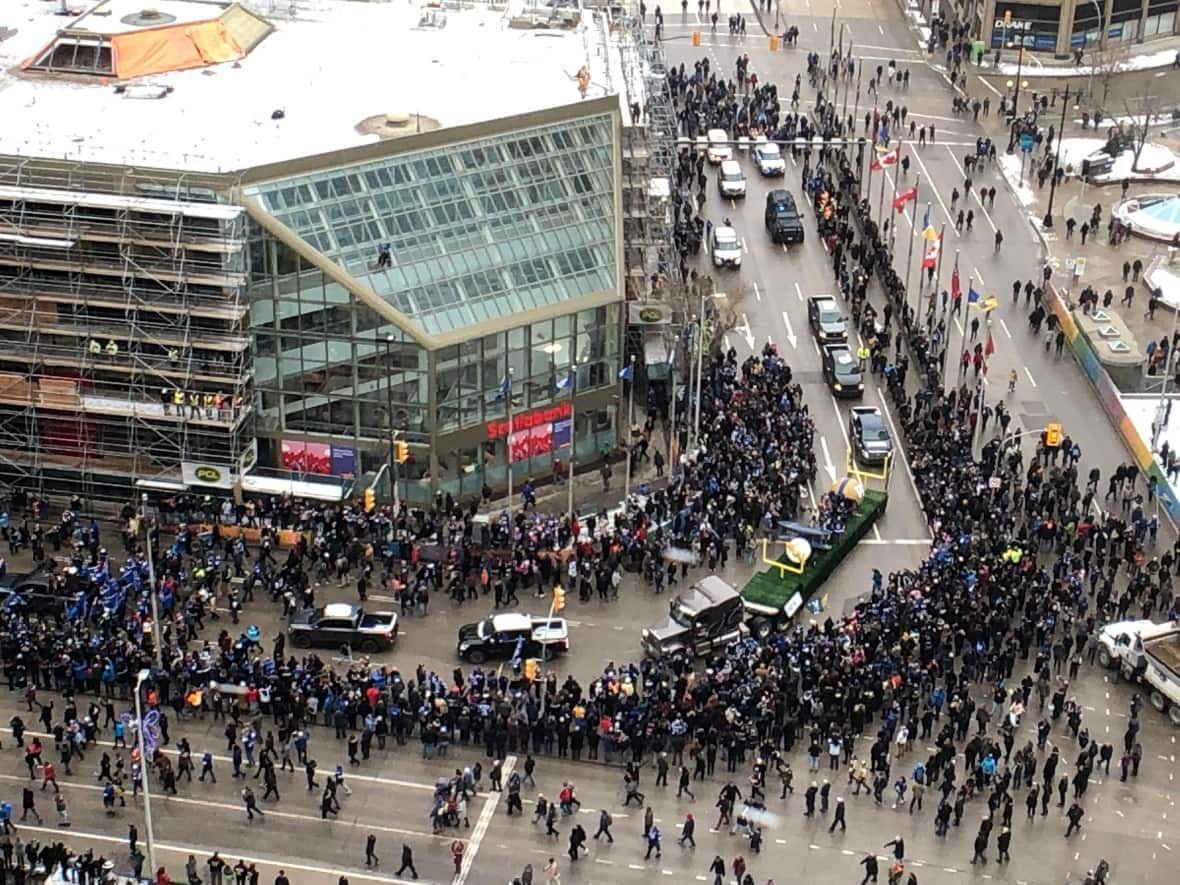 Thousands of people march through Portage and Main after the Winnipeg Blue Bombers won the Grey Cup in 2019. Winnipeg's mayor is now in favour of reopening the intersection permanently. (Justin Deeley/CBC - image credit)