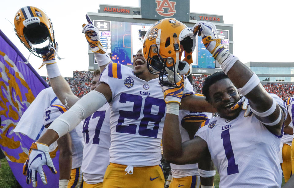 LSU players celebrate after they defeated Auburn on a last second field goal during the second half of an NCAA college football game, Saturday, Sept. 15, 2018, in Auburn, Ala. LSU won 22-21. (AP Photo/Butch Dill)