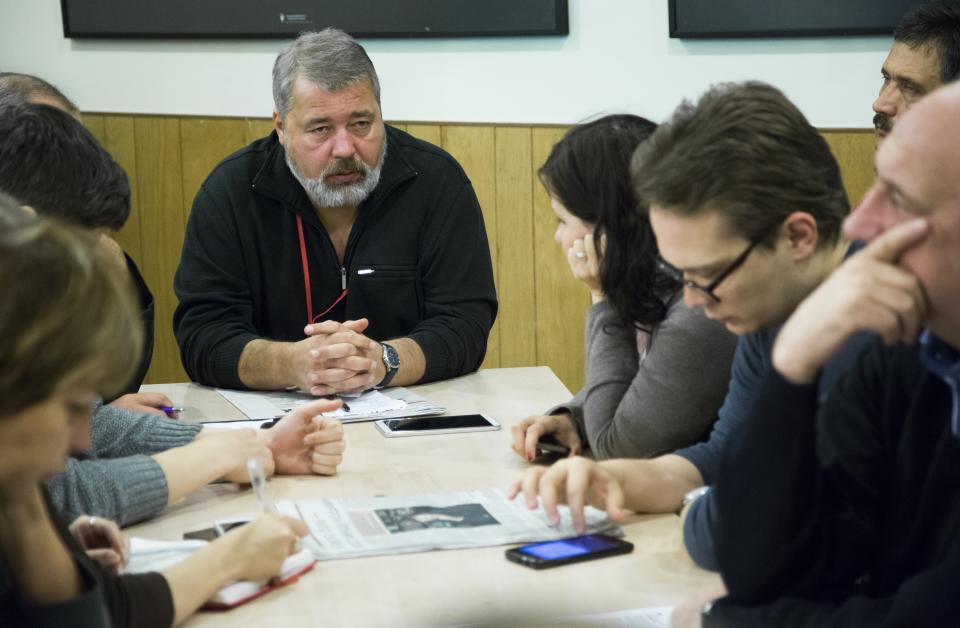 FILE - In this Friday, Oct. 9, 2015, file photo, Dmitry Muratov, the editor of Novaya Gazeta, center left, attends a planning meeting with the editorial board, in Moscow, Russia. As a new Nobel Peace Prize laureate, Russian newspaper editor Dmitry Muratov has downplayed the buzz around his name. The award isn't for him, he says, but for all of the staff at Novaya Gazeta, the independent Russian newspaper noted for investigations of official corruption, human rights abuses and Kremlin criticism. (AP Photo/Alexander Zemlianichenko, File)