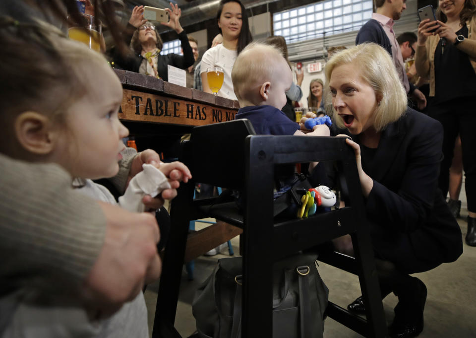 Democratic presidential candidate Sen. Kirsten Gillibrand, D-N.Y., plays with 7-month-old Bodie Nichols of Bedford, N.H. as his sister Emmie, 2, watches at left during a campaign meet-and-greet, Friday, March 15, 2019, at To Share Brewing in Manchester, N.H. (AP Photo/Elise Amendola)