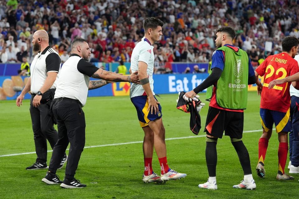 Spain striker Alvaro Morata looked in pain after colliding with a security guard (Bradley Collyer/PA Wire)