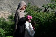 Starting at dawn and working until late morning when the heat sets in, the Afghan workers appear resigned to the constant dangers lurking around them as they quickly pick off petals and drop them into large bags