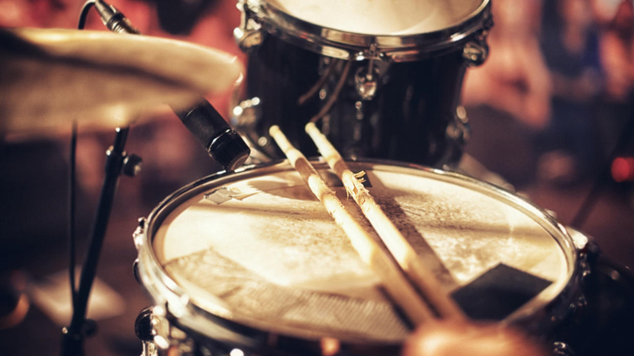  Snare drum with microphone, woman playing drums. 