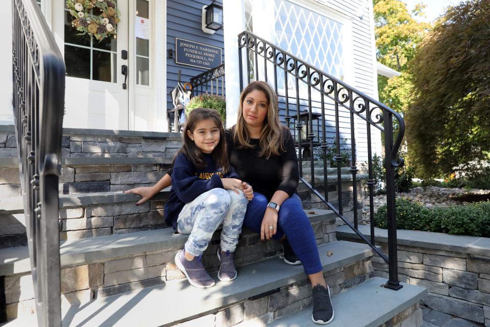 Leslie Chiaramonte and her 6 year-old daughter Brooklyn, who is on hybrid school schedule, sit outside the funeral home family business Oct. 7, 2020 in Peekskill. Chiaramonte was a nurse case manager at White Plains Hospital who had to quit last month to watch after her daughters. She also has a three-year-old.