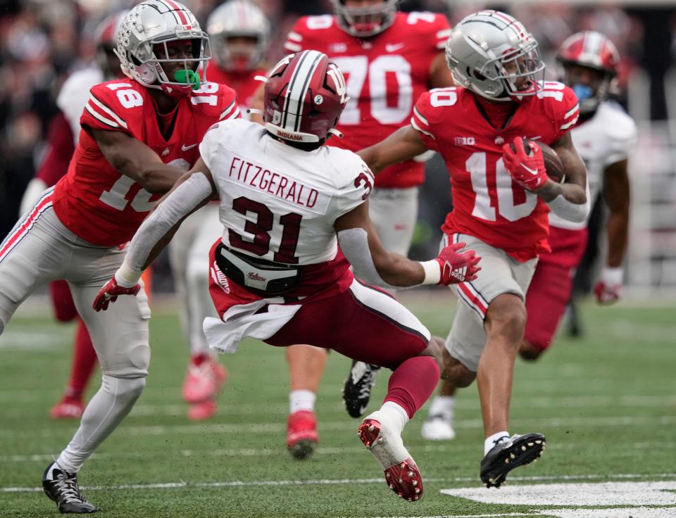 Ohio State wide receiver Xavier Johnson (10) runs for a 71-yard touchdown against Indiana, while Marvin Harrison Jr. makes a block.