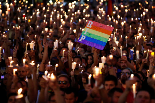 People take part in a candlelight memorial service on Monday night, the day after a mass shooting at the gay nightclub Pulse in Orlando. (Photo: Carlo Allegri/Reuters)
