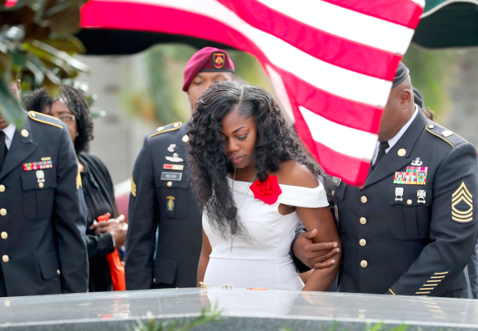 Myeshia Johnson looks down at the coffin of her husband, David (Picture: Rex)