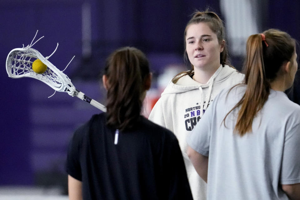 Northwestern's Izzy Scane talks with teammates during the lacrosse team's practice in Evanston, Ill., Tuesday, Feb. 6, 2024. (AP Photo/Nam Y. Huh)